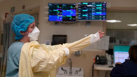 A nurse suits up with protective gear before entering a patient's room January 3 at the Covid-19 ICU at Dartmouth-Hitchcock Medical Center, in Lebanon, New Hampshire.