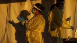 Healthcare workers are pictured at a drive-thru Covid-19 testing site in El Paso, Texas on January 12, 2022. - The country is currently seeing an average of 750,000 cases a day -- though that figure is soon expected to exceed a million -- around 150,000 total Covid hospitalizations, and more than 1,600 daily deaths. (Photo by PAUL RATJE / AFP) (Photo by PAUL RATJE/AFP via Getty Images)