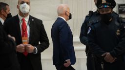 US President Joe Biden (C) arrives to meet with the Senate Democratic Caucus on Capitol Hill in Washington, DC on January 13, 2022.
