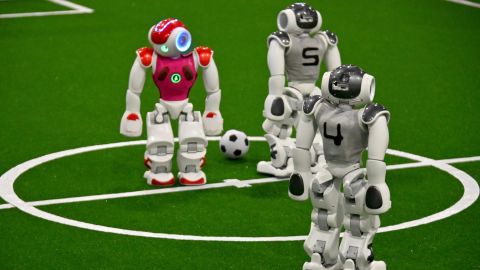 Robots play football at the RoboCup 2019 event in Sydney on July 4, 2019. - About 170 teams from more than 30 countries gathered in Sydney for the annual RoboCup event which sees robot soccer teams go head to head in an event designed to enhance development of artificial intelligence and robotics. (Photo by Peter PARKS / AFP)        (Photo credit should read PETER PARKS/AFP via Getty Images)
