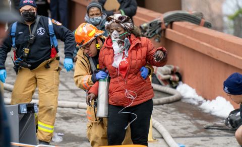 A woman receives medical assistance after being rescued from an apartment fire in the Bronx, New York, on Sunday, January 9. 
