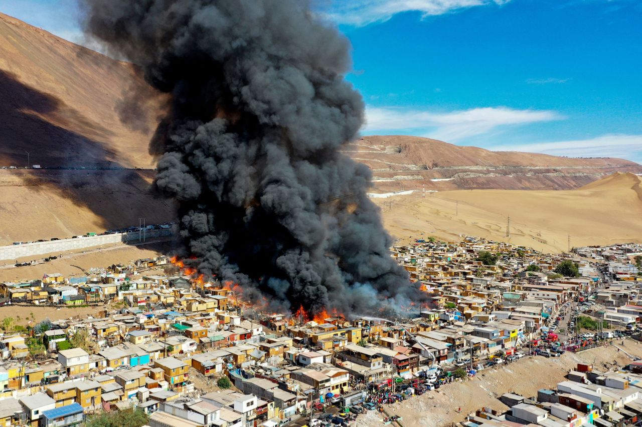 Fire engulfs part of the Laguna Verde camp in Iquique, Chile, on Monday, January 10. About 100 homes were consumed by the fire.
