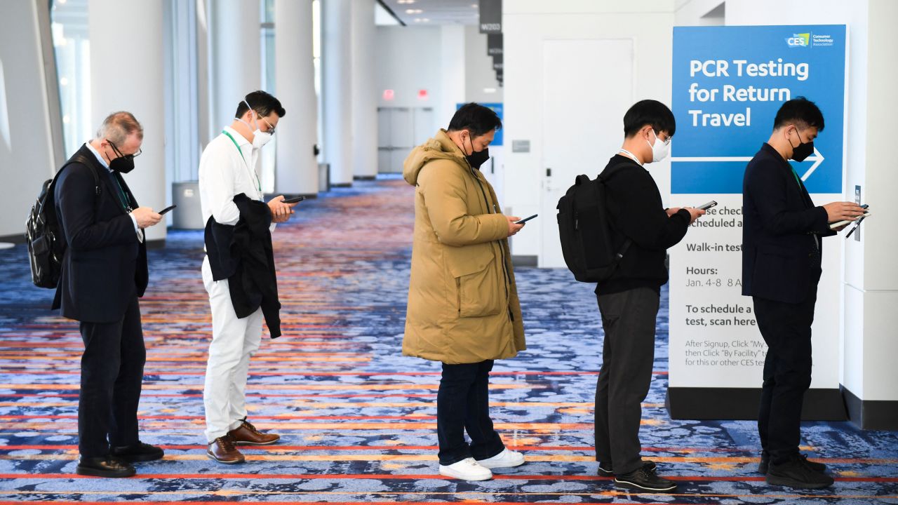 Attendees wear face masks as they wait in line for Covid-19 PCR testing for travel during the Consumer Electronics Show on January 7, 2022, in Las Vegas.