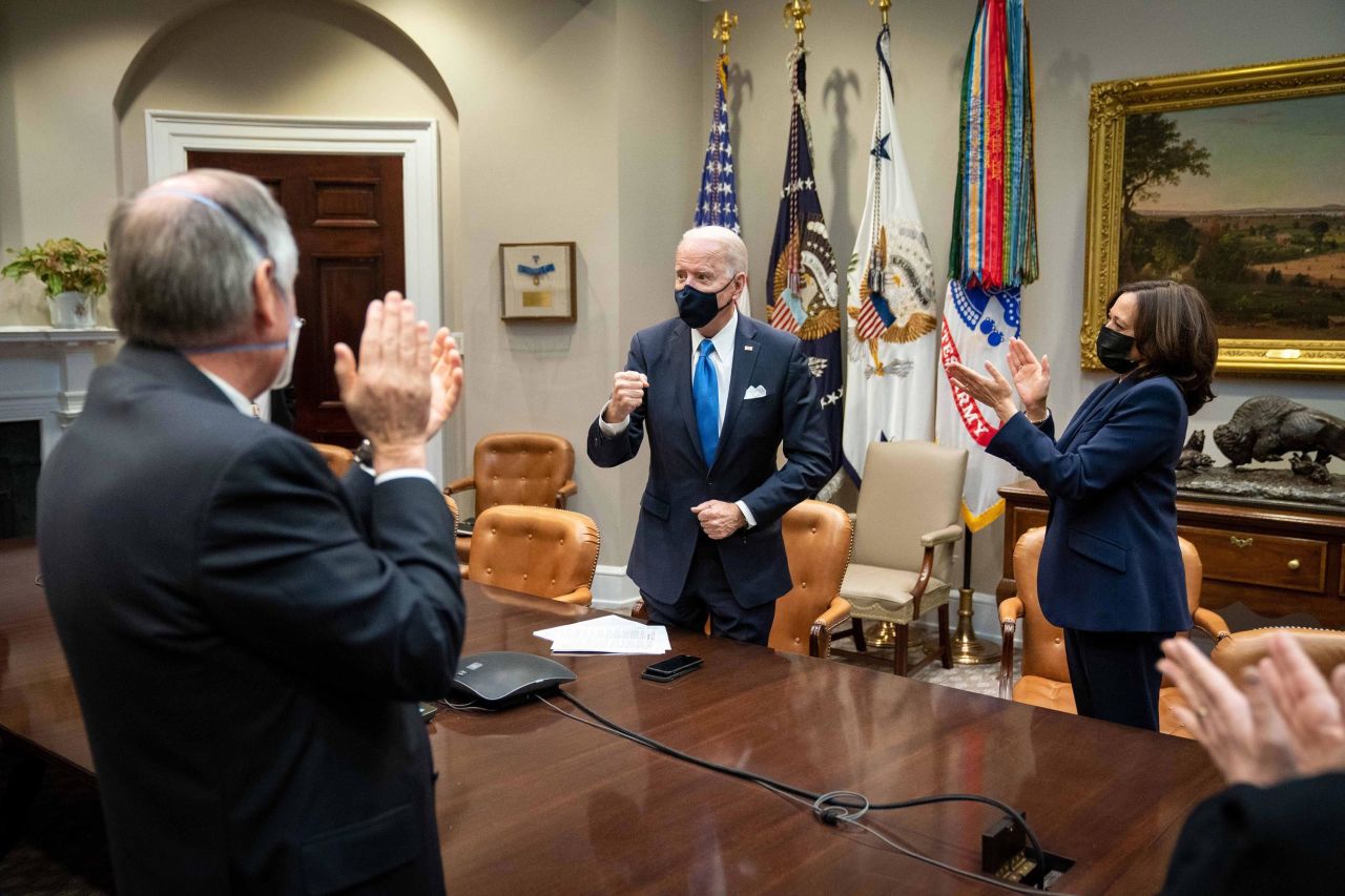 Biden and Harris, joined by White House staff, applaud as they watch the House of Representatives approve a $1.9 trillion economic relief plan on March 10. <a href="https://www.cnn.com/2021/03/11/politics/biden-sign-covid-bill/index.html" target="_blank">The Covid-19 relief package</a> had been Biden's first and most pressing legislative priority since taking office in January.<br /><br />"This historic legislation is about rebuilding the backbone of this country and giving people in this nation — working people, middle-class folks, people who built the country — a fighting chance," Biden said before he signed the legislation. "That's what the essence of it is."