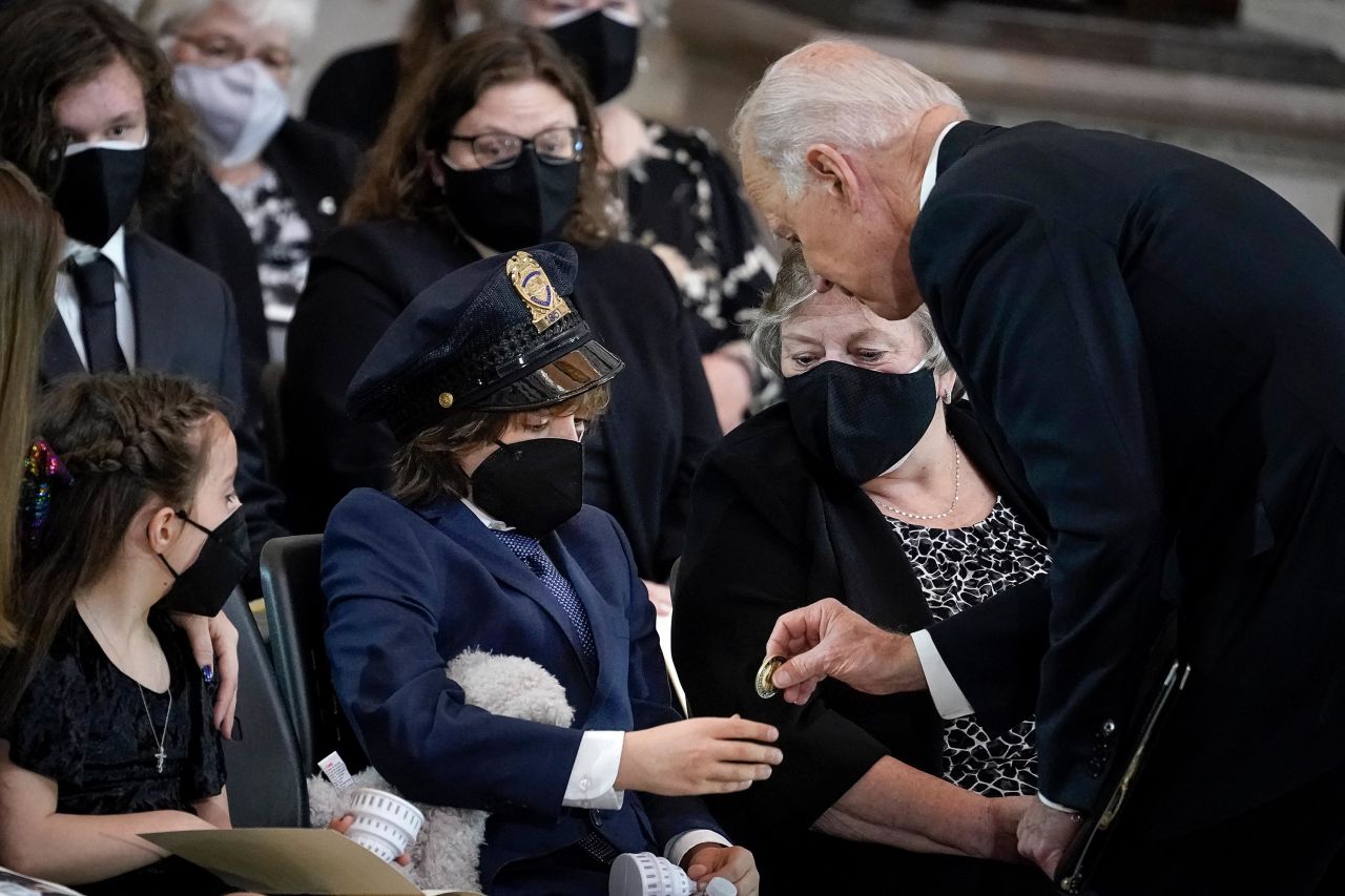 Biden gives a challenge coin to Logan Evans, son of the late Capitol Police Officer William "Billy" Evans, as the fallen officer was <a href="https://www.cnn.com/2021/04/13/politics/capitol-police-officer-lie-in-honor-ceremony/index.html" target="_blank">lying in honor in the US Capitol Rotunda</a> on April 13. Billy Evans, 41, died on April 2 after a man brandishing a knife rammed his vehicle into a police barricade outside the Capitol. <br /><br />Biden told Evans' mother: "I have some idea what you're feeling like. I buried two of my children." The President's first wife and daughter died in a car crash in 1972. Biden's son Beau died in 2015 of brain cancer.<br /><br />Logan wore the police hat and clutched a stuffed animal for most of the memorial service, photographer Drew Angerer said.