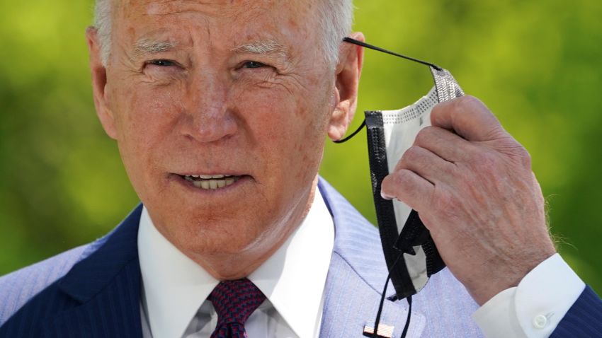 U.S. President Joe Biden removes his face mask as he delivers remarks on the administration's coronavirus disease (COVID-19) response outside the White House in Washington, U.S., April 27, 2021. REUTERS/Kevin Lamarque