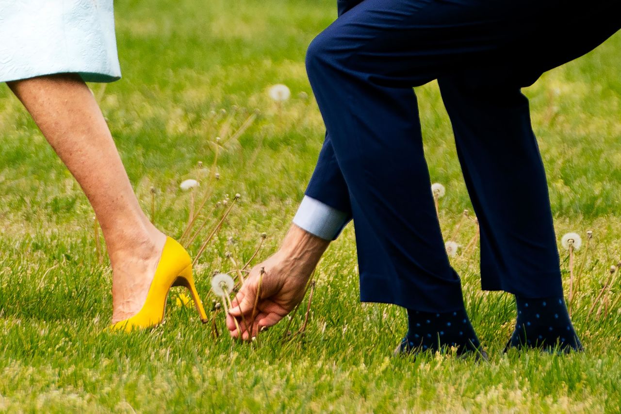 Biden picks up a dandelion for the first lady as they walk to Marine One at the White House on April 29.<br /><br />"Departures and arrivals are so routine, and most of the time nothing happens," Washington Post photographer Demetrius Freeman said. "But this time I noticed (the President) looking down. He then stopped and picked the dandelion and presented it to (the first lady).<br /> <br />"(The President) tends to stick to the routine, but in this moment he showed a very spontaneous, kind moment."