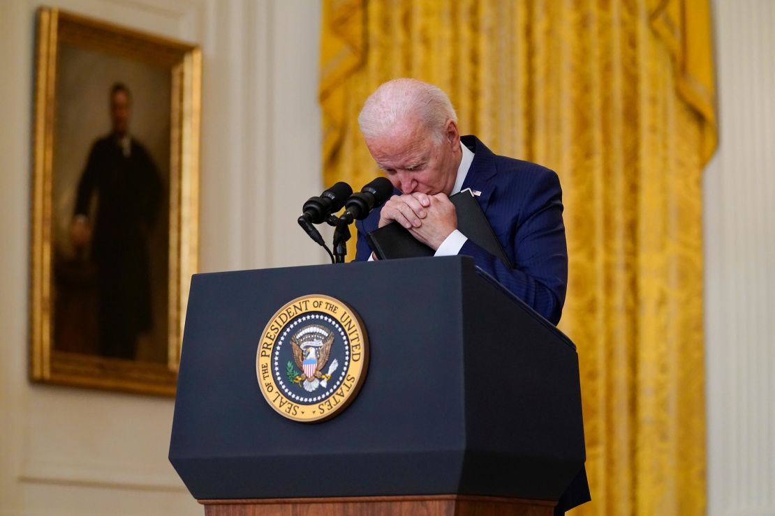 President Joe Biden pauses as he listens to a question about the bombings at the Kabul airport that killed at least 12 U.S. service members, from the East Room of the White House in August 2021.