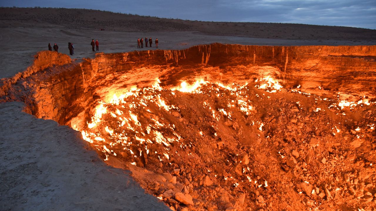 Visitors line the edge of the Darvaza 'Gates Of Hell' gas crater in Karakum Desert, Turkmenistan, in May, 2017.