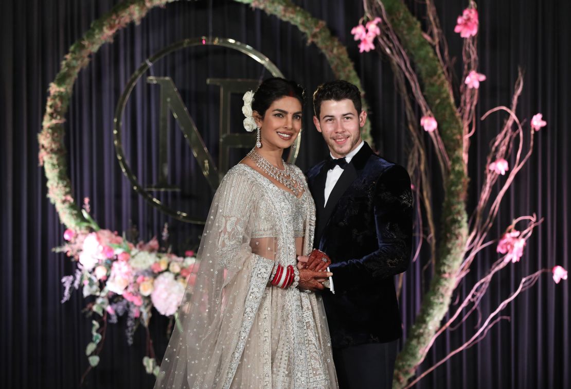 Newlyweds Priyanka Chopra and Nick Jonas pose for photographs during a reception in New Delhi on  December 4, 2018. 