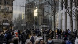 Shoppers wait in line at the Fifth Avenue Apple Store in New York, U.S., on Monday, Dec. 27, 2021. U.S. holiday sales jumped 8.5% from last year as consumers spent more money on clothes, jewelry and electronics, a report from Mastercard SpendingPulse showed. 