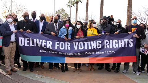 Rep. Ruen Gallego, left, the King family, middle, and other local activists lead the march across the 16th Street overpass to call for voting rights in honor of Martin Luther King Jr. on January 15, 2022, in Phoenix, Arizona.