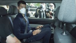 Serbian tennis player Novak Djokovic rides in car as he leaves a government detention facility before attending a court hearing at his lawyers office in Melbourne, Australia, Sunday, January 16, 2022.