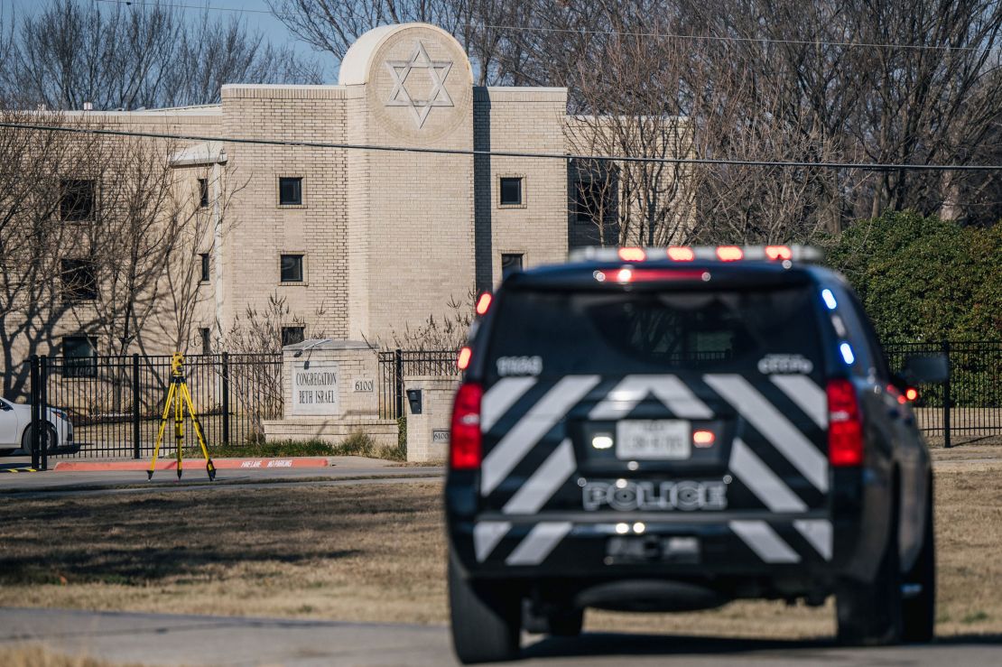 A police SUV sits outside the synagogue Sunday.