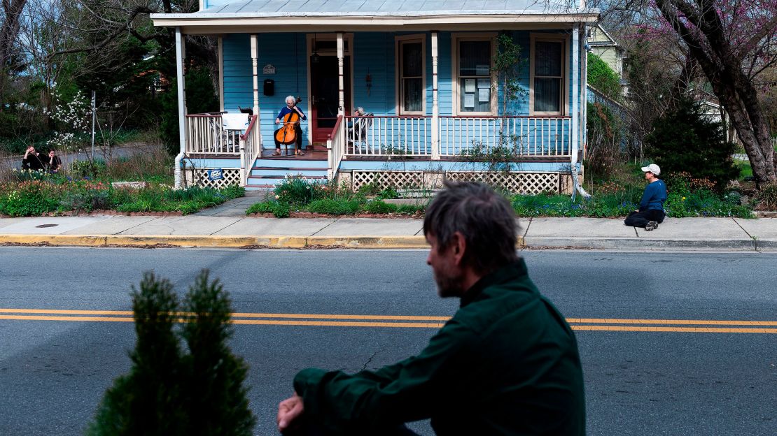 Cellist Jodi Beder performs a daily concert on her front porch in Mount Rainier, Maryland, on March 30, 2020. Beder started the performances to help her neighbors cope with the Covid-19 pandemic. 