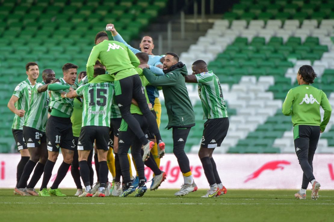 Real Betis players celebrate in an empty stadium after the full time whistle on Sunday.