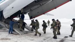 Russian servicemen board a military aircraft on their way to Kazakhstan, at an airfield outside Moscow, Russia,, on January 06, 2022.