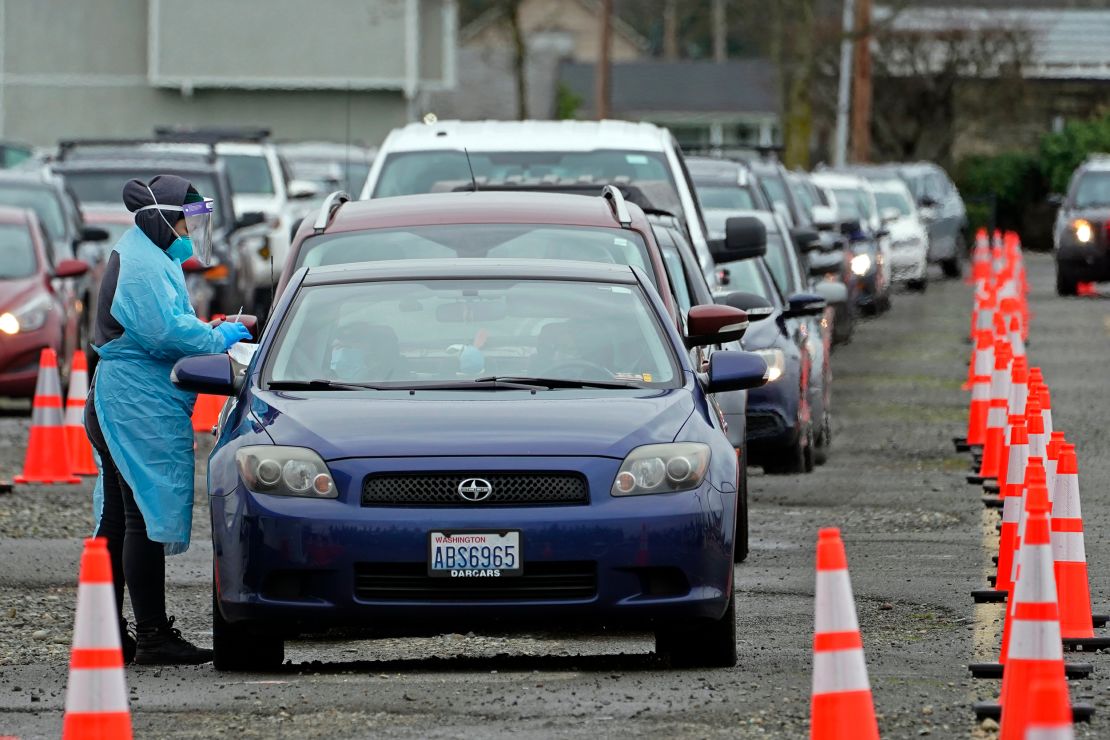 A worker at a drive-up coronavirus testing clinic administers PCR coronavirus tests in Puyallup, Washington state, on January 4.