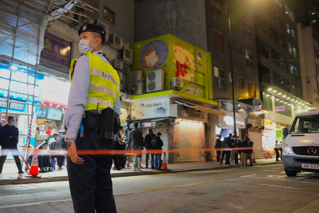 A police officer stands guard outside a pet store that was closed after some pet hamsters tested positive for Covid-19 in Hong Kong on January 18.