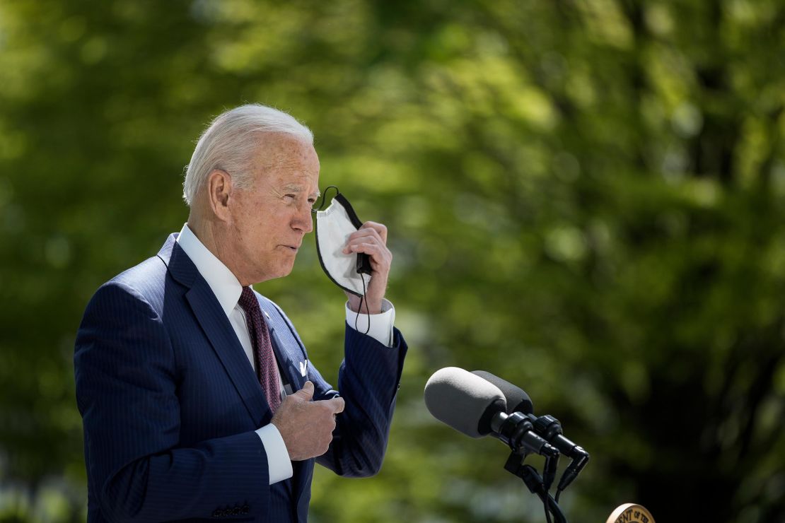 President Joe Biden removes his mask before speaking about updated CDC mask guidance on the North Lawn of the White House on April 27, 2021 in Washington, DC.