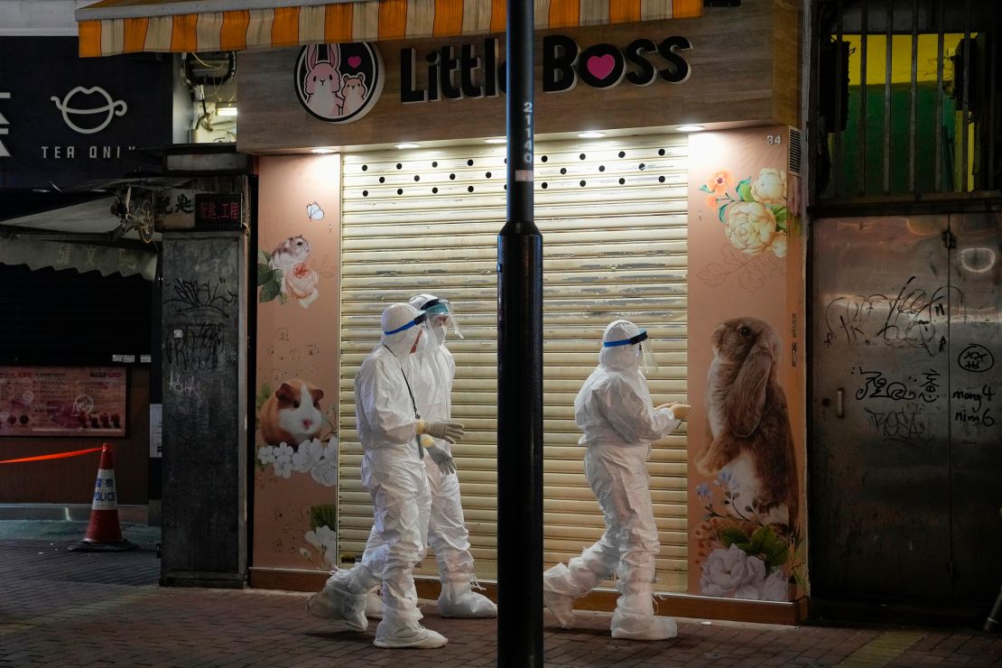 Government workers investigate a pet shop that closed after some pet hamsters tested positive for the coronavirus in Hong Kong on January 18.