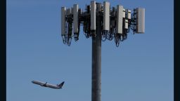 SAN FRANCISCO, CALIFORNIA  - JANUARY 18: A United Airlines plane flies by a cellular tower as it takes off from San Francisco International Airport  on January 18, 2022 in San Francisco, California. Verizon and AT&T announced that they will proceed with plans to activate 5G cellular service across the nation on Wednesday with the exception of near airports and runways after the Federal Aviation Administration and major airlines warned that the signal could interfere with navigational systems on some planes and cause flight disruptions. (Photo by Justin Sullivan/Getty Images)
