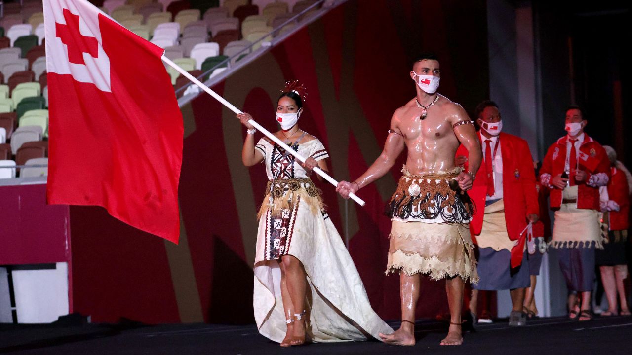 Flag bearers Malia Paseka and Pita Taufatofua lead the Tongam team out during the Opening Ceremony of the Tokyo 2020 Olympic Games at Olympic Stadium on July 23, 2021 in Tokyo, Japan.