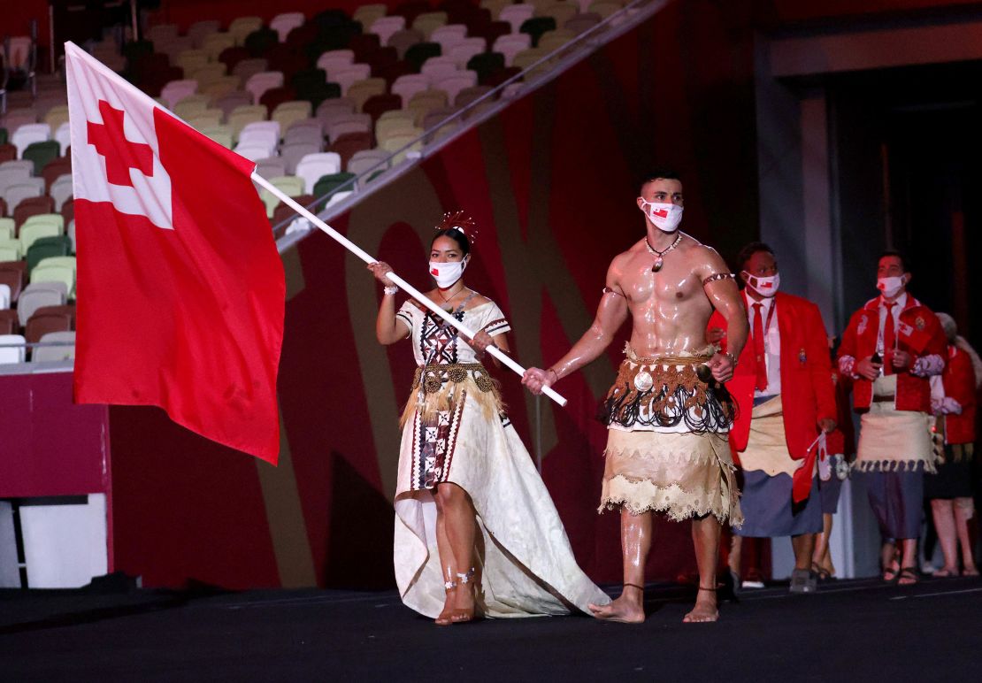 Flag bearers Malia Paseka and Pita Taufatofua lead the Tongam team out during the Opening Ceremony of the Tokyo 2020 Olympic Games at Olympic Stadium on July 23, 2021 in Tokyo, Japan.