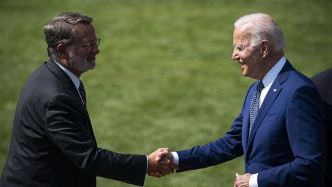Biden shakes hands with Sen. Gary Peters, chair of the DSCC, left, during an event on the South Lawn of the White House in August 2021. 