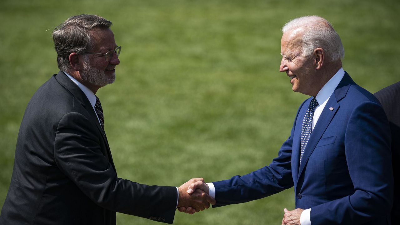 Biden shakes hands with Sen. Gary Peters, chair of the DSCC, left, during an event on the South Lawn of the White House in August 2021.