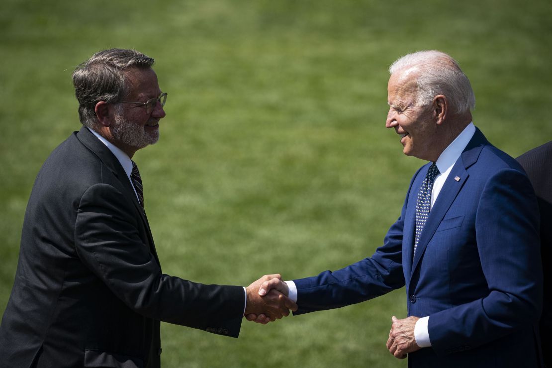 Biden shakes hands with Sen. Gary Peters, chair of the DSCC, left, during an event on the South Lawn of the White House in August 2021. 