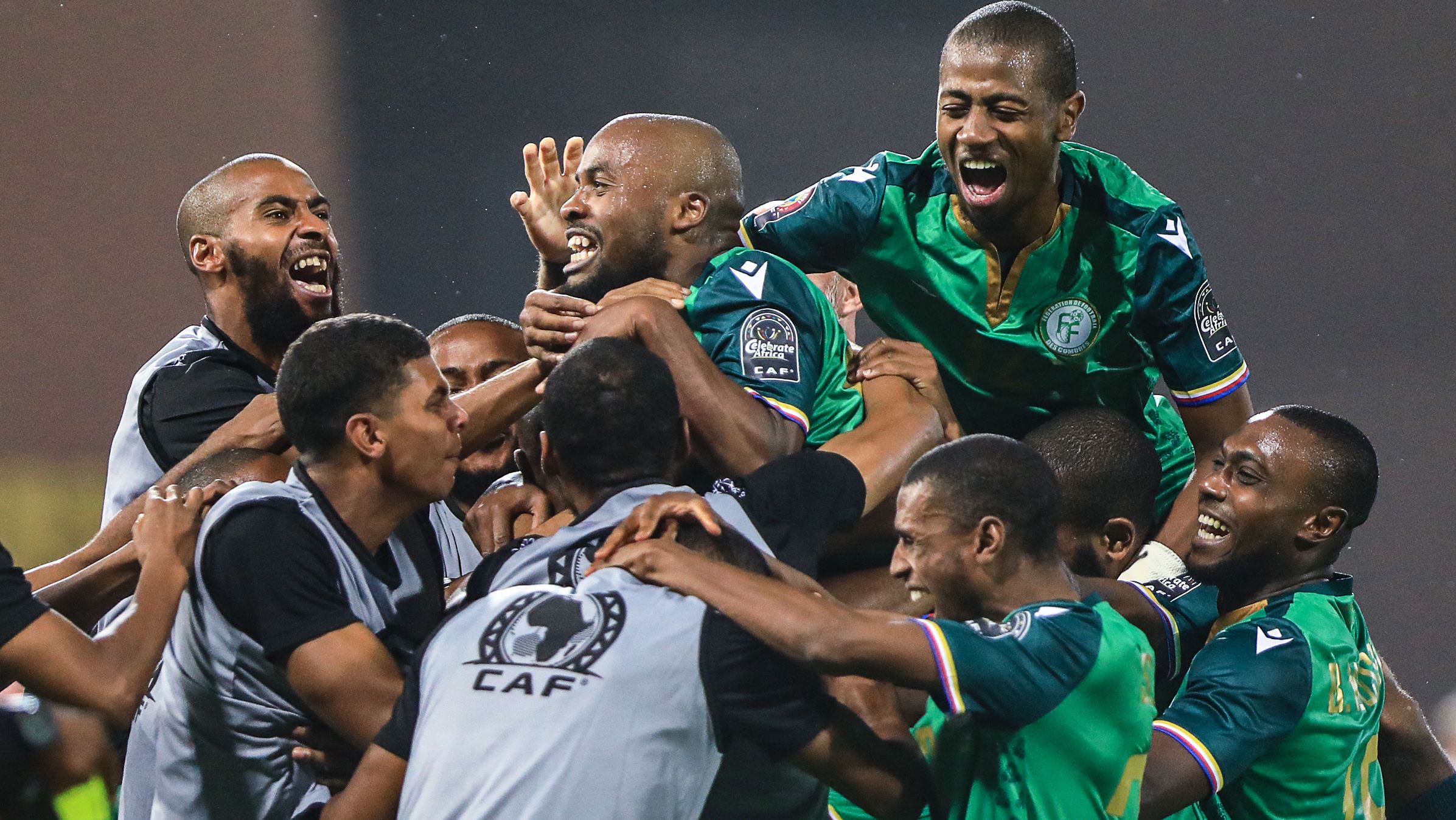 Comoros' forward Ahmed Mogni celebrates with teammates after scoring during the win over Ghana.