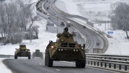 A convoy of Russian armored vehicles moves along a highway in Crimea, on Tuesday, January 18. Russia has concentrated an estimated 100,000 troops with tanks and other heavy weapons near Ukraine in what the West fears could be a prelude to an invasion. 