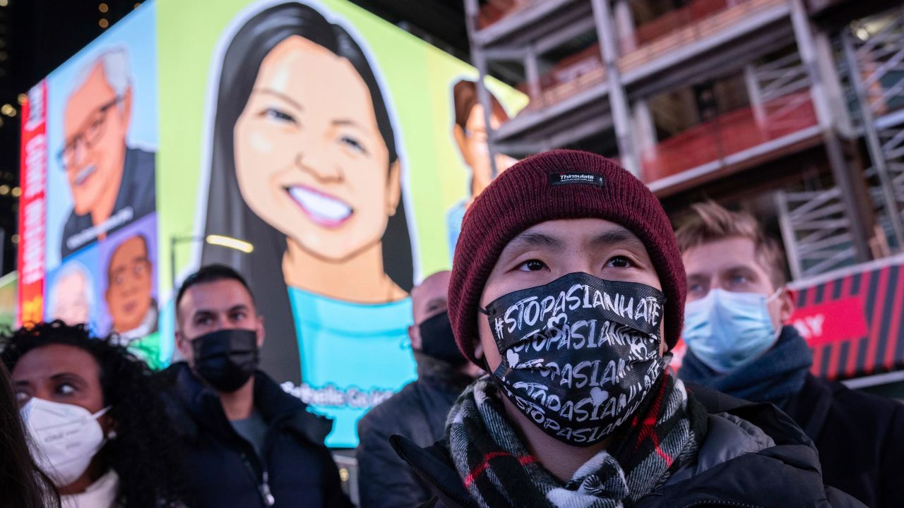 A person wearing a face mask that reads, "Stop Asian Hate," attended a candlelight vigil in honor of Michelle Alyssa Go on Tuesday.