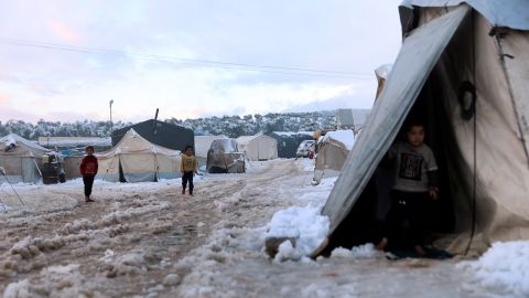 Children walk in the snow at a camp for internally displaced people in Afrin, Syria, on Tuesday.