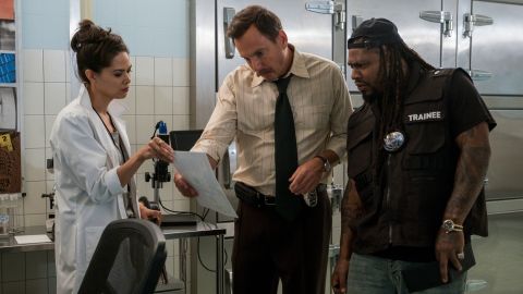 (From left) Lilan Bowden as Amber Kang, Will Arnett as Terry Seattle, and guest star Marshawn Lynch in an episode of "Murderville." 