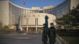 People's Liberation Army soldiers stand in front of the People's Bank of China (PBOC) in Beijing, China, on Monday, Dec. 13, 2021.