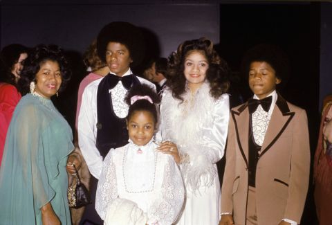  Janet Jackson, front center, attends older brother Jermaine Jackson's wedding in December 1973. She's with her mother Katherine, sister La Toya, and brothers Randy and Michael. 