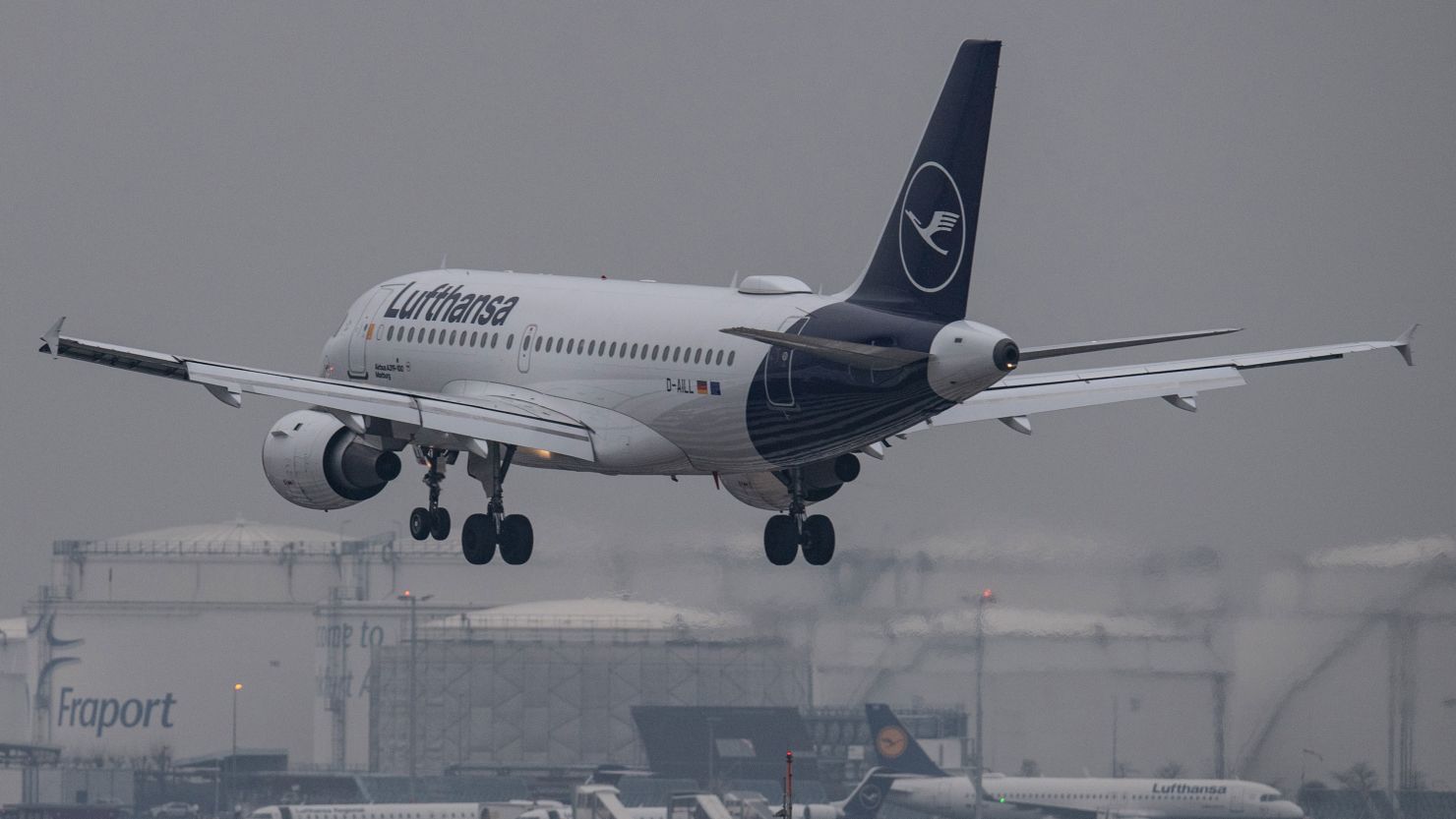 A Lufthansa passenger plane lands in dense fog at Frankfurt Airport. 