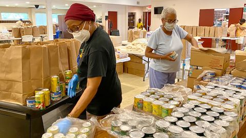 Volunteers organize food boxes at Beyond the Sanctuary, a non-profit organization in Rochester, New York, in June 2021. 