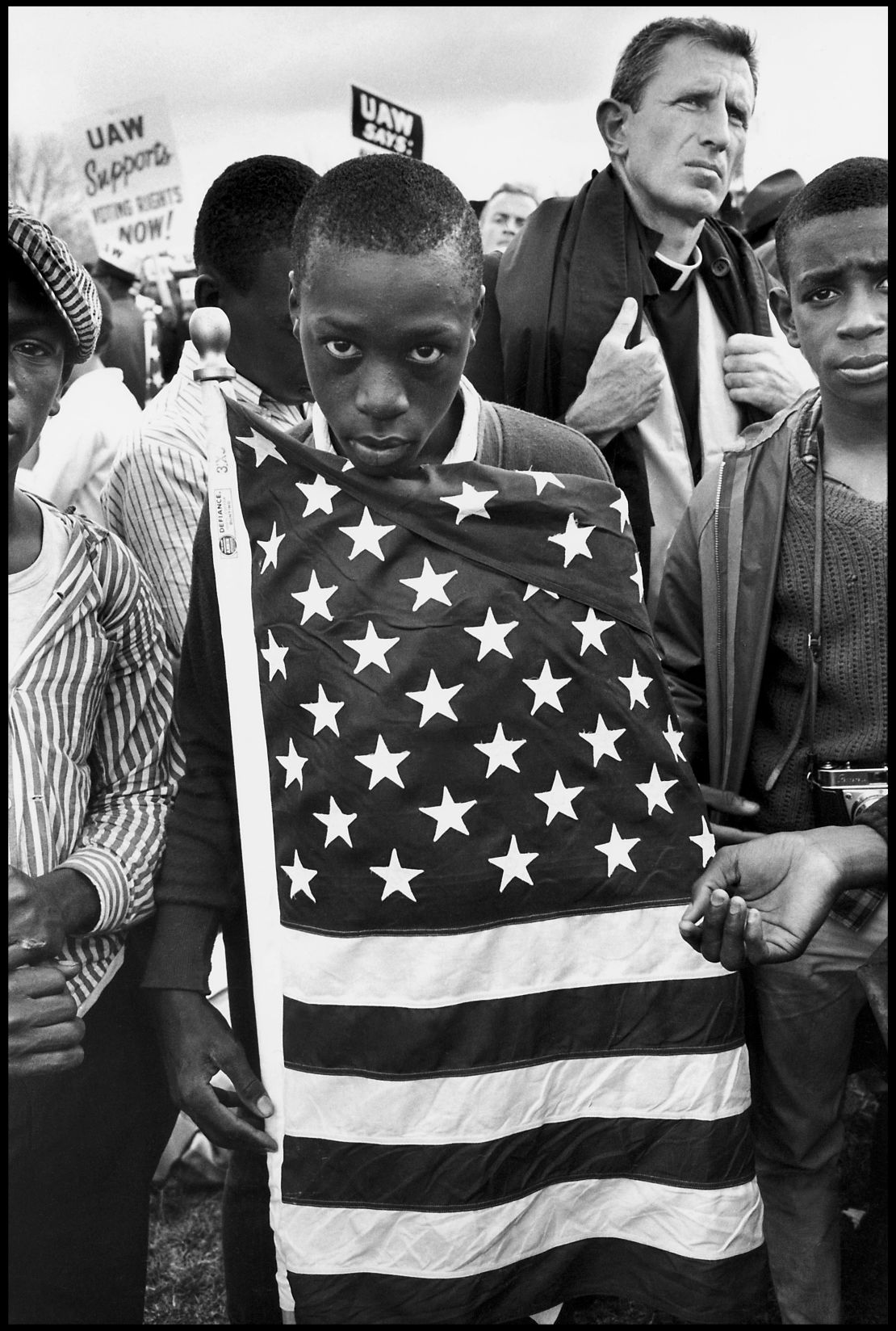 The Selma March, Alabama, 1965. "The direct gaze of this young man, his defiance and his ownership of that flag are so powerful," said curator Sophie Wright.