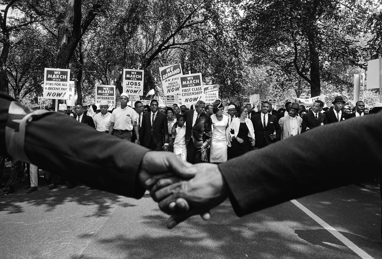Protesters take part in the March on Washington in 1963. At center is baseball player Jackie Robinson, with his arm around his son David. Rosa Parks is also in front, wearing a black dress with a white jacket. 