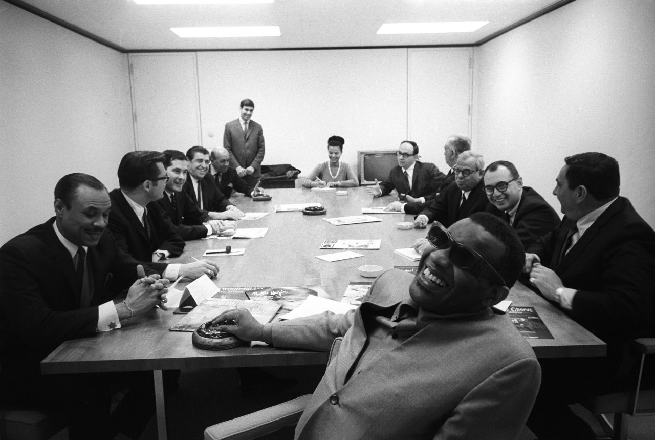 Musician Ray Charles sits at a table full of executives in 1971.