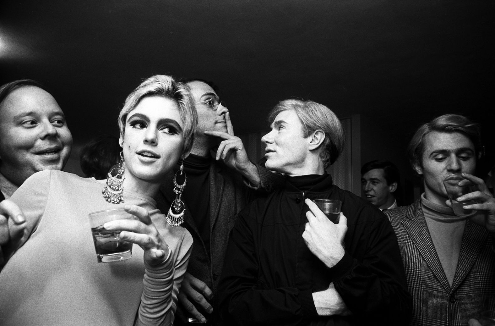 From left, art critic Henry Geldzahler, actress Edie Sedgwick, actor Fu-Fu Smith, artist Andy Warhol and poet Gerard Malanga attend a party in New York in 1965.