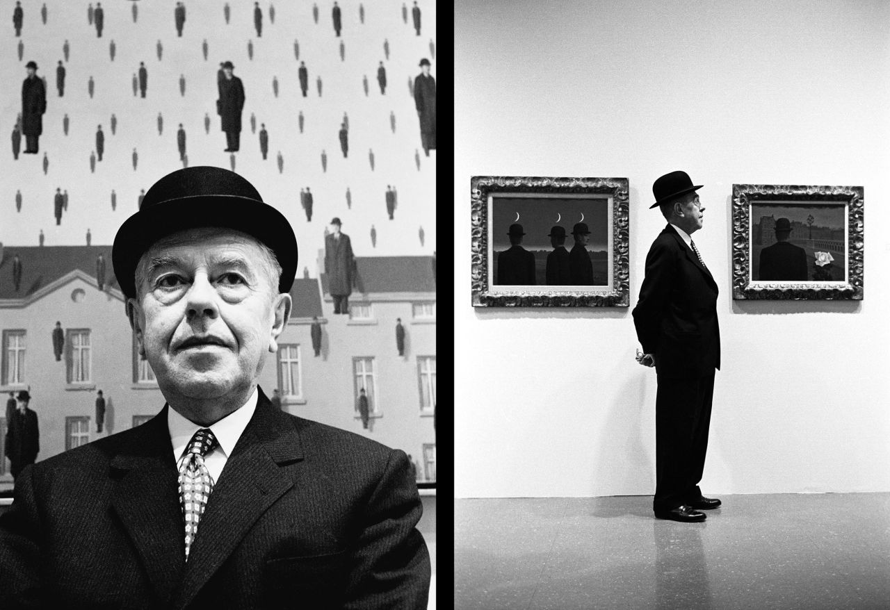 Surrealist painter Rene Magritte is photographed near some of his paintings at the Museum of Modern Art in New York in 1965.