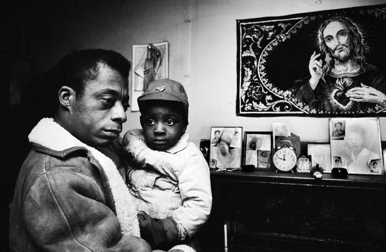 Writer James Baldwin comforts an abandoned child at a neighbor's home in Durham, North Carolina, in 1963.