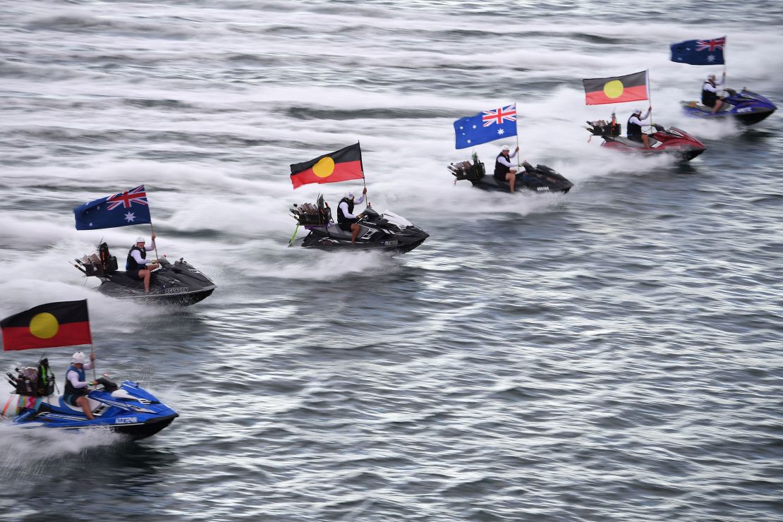Jetskis fly the Australian and Aboriginal flags during Australia Day celebrations in Sydney on January 26, 2021. 