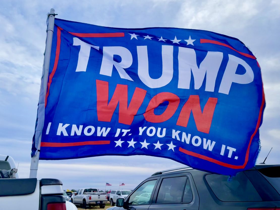 A large flag declaring the Big Lie of the 2020 election flies in Florence, Arizona, ahead of a rally by former President Donald Trump.