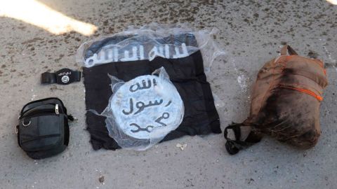 This photo provided by the Kurdish-led Syrian Democratic Forces shows the flag and bags of Islamic State group fighters who were captured by the SDF after the prison attack.