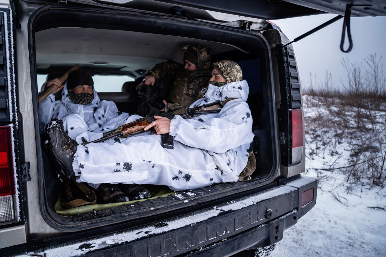 Soldiers sit in the back of a truck in Slov'yanoserbs'k, Ukraine.